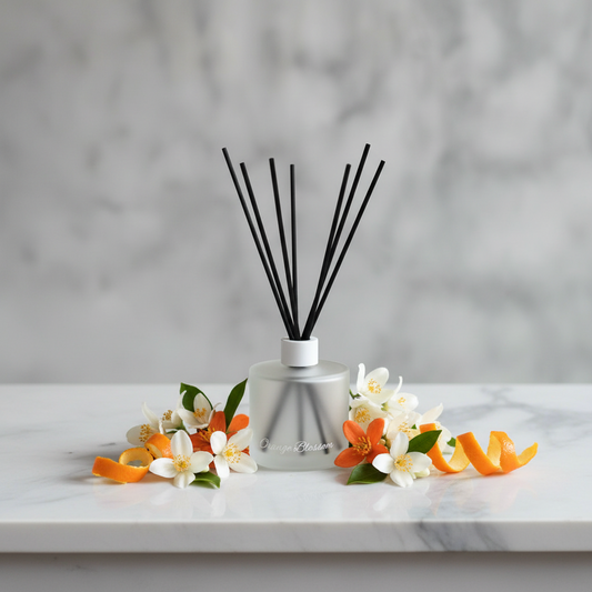 Diffuser with black sticks in a clear container on a white background