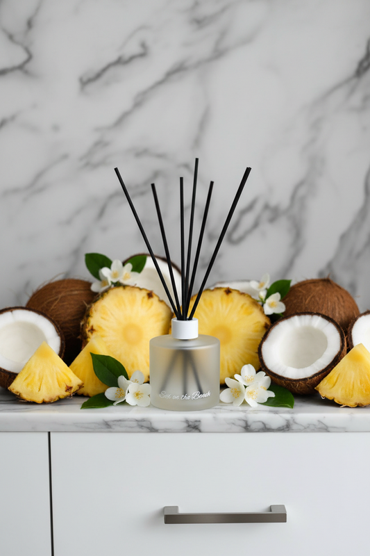 Silver diffuser with black sticks on a white background