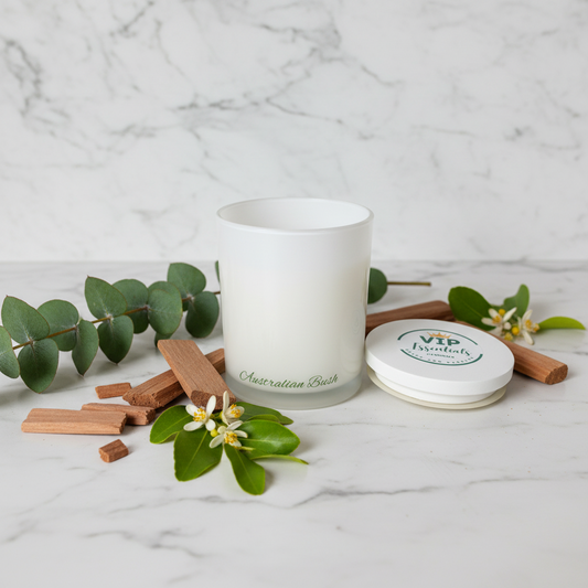 White candle in a glass container with a lid labeled 'VIP Essentials' on a white background