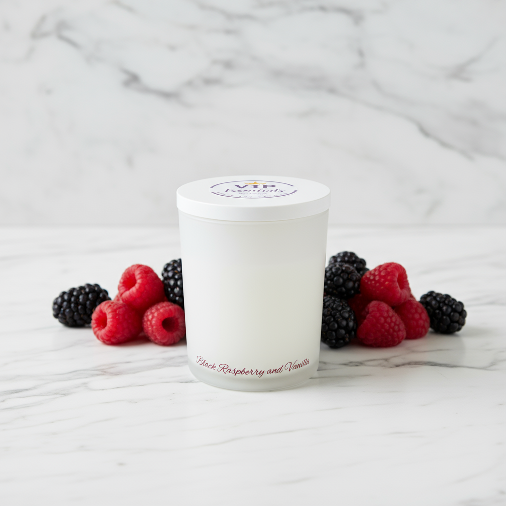 White candle with raspberry and vanilla scent surrounded by raspberries and blackberries on a marble surface