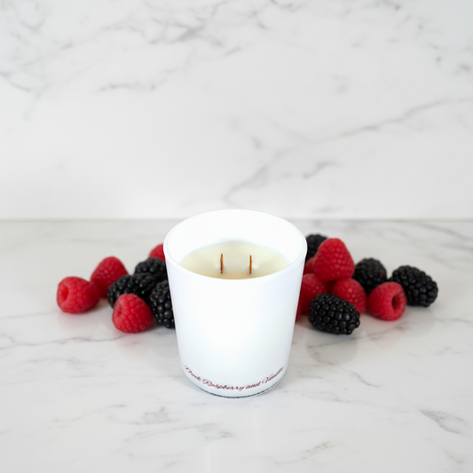 White candle in a glass container on a blue background