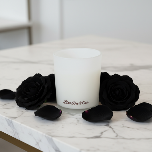 White candle labeled 'Black Rose & Oak' with black roses on a marble surface