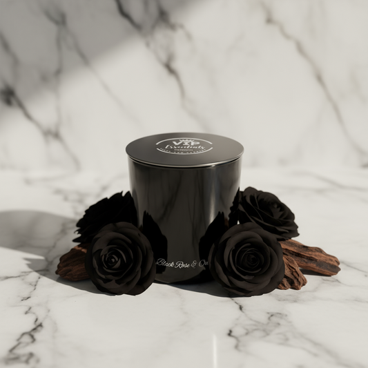 Black candle with black roses on a marble surface