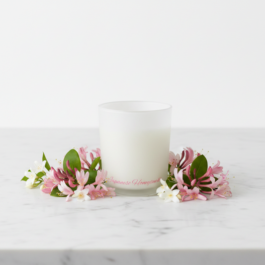 White candle in a glass container with 'Japanese Home' branding on a white background