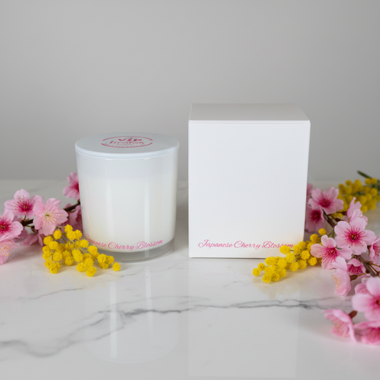 A frosted white cylindrical bottle with a matching white box, both featuring pink text that reads 'VIP Flower Shop' and 'Japanese Cherry Blossom' on a plain white background.