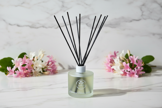 Diffuser with black sticks on a light background with flowers