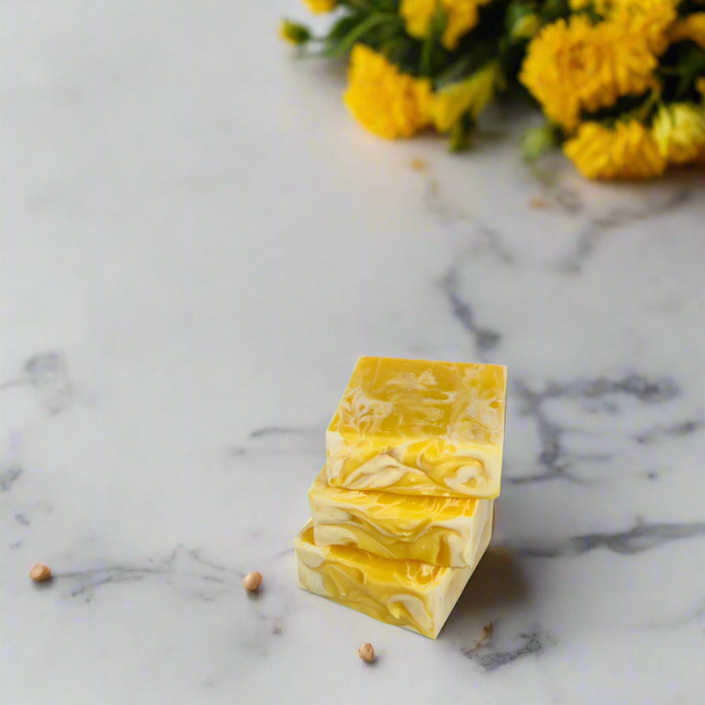 Stack of yellow soap bars on a marble surface with yellow flowers in the background