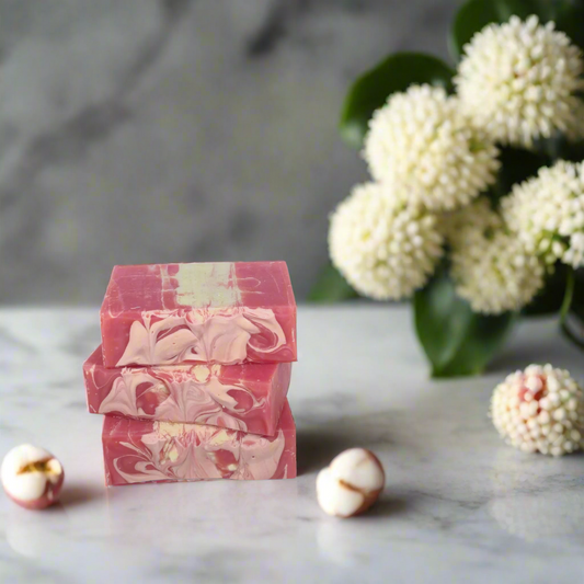 Stack of pink and white marbled soap bars on a blue background