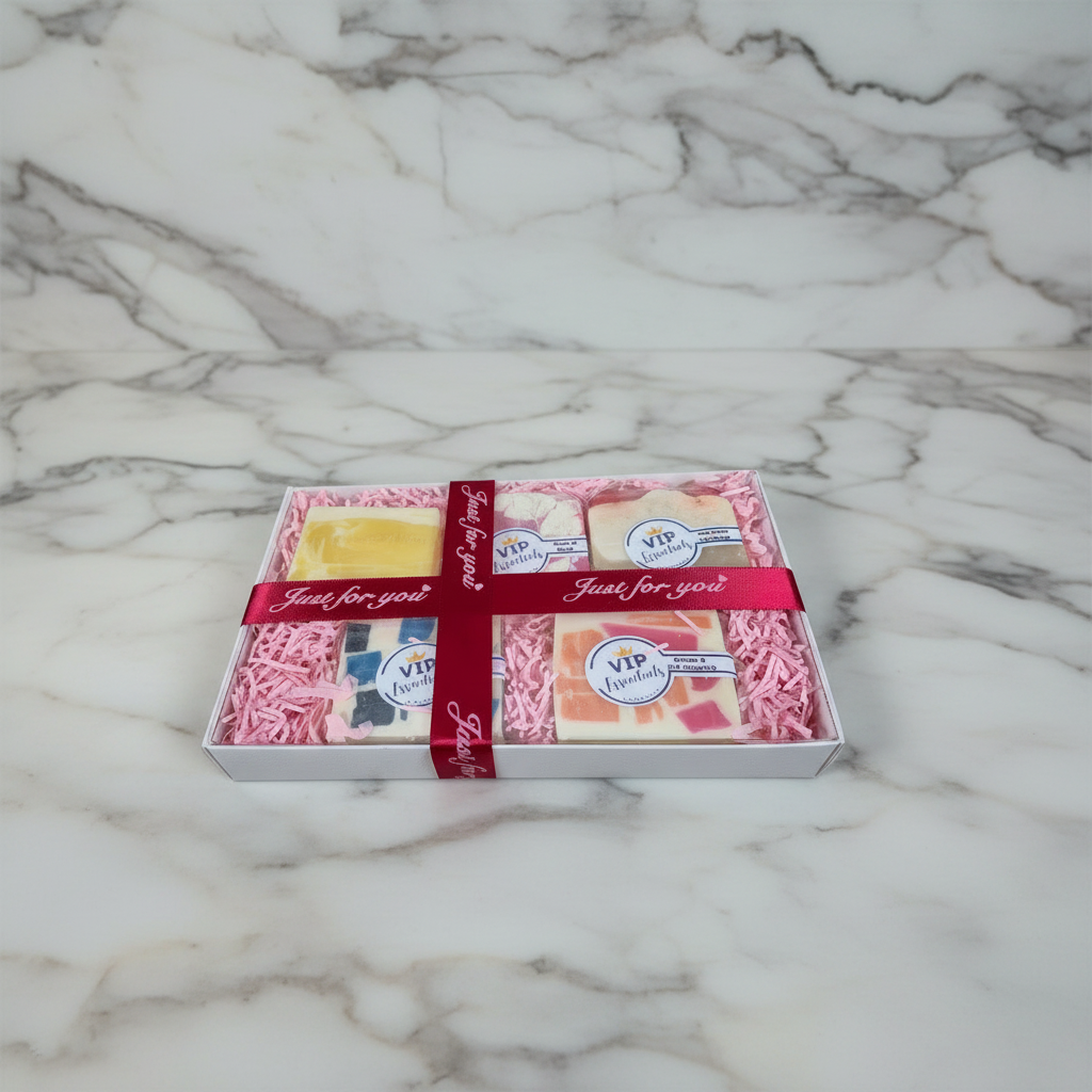 Box of soap bars with a red ribbon on a marble surface