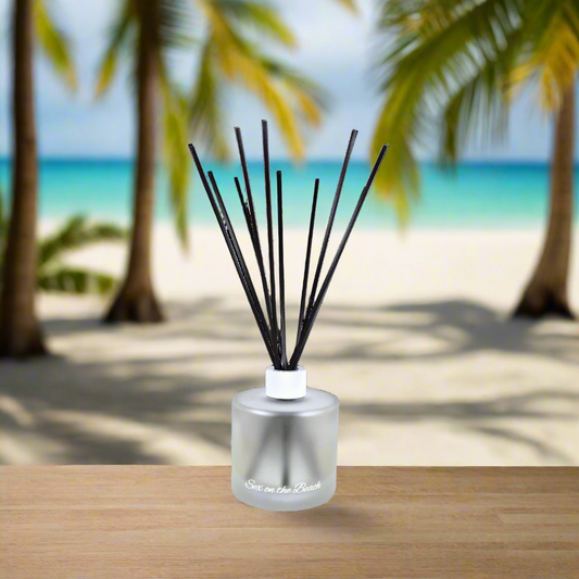 Diffuser with black sticks on a beach setting